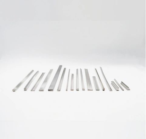 Various stainless steel shaped wire and profile cross-sections on white background